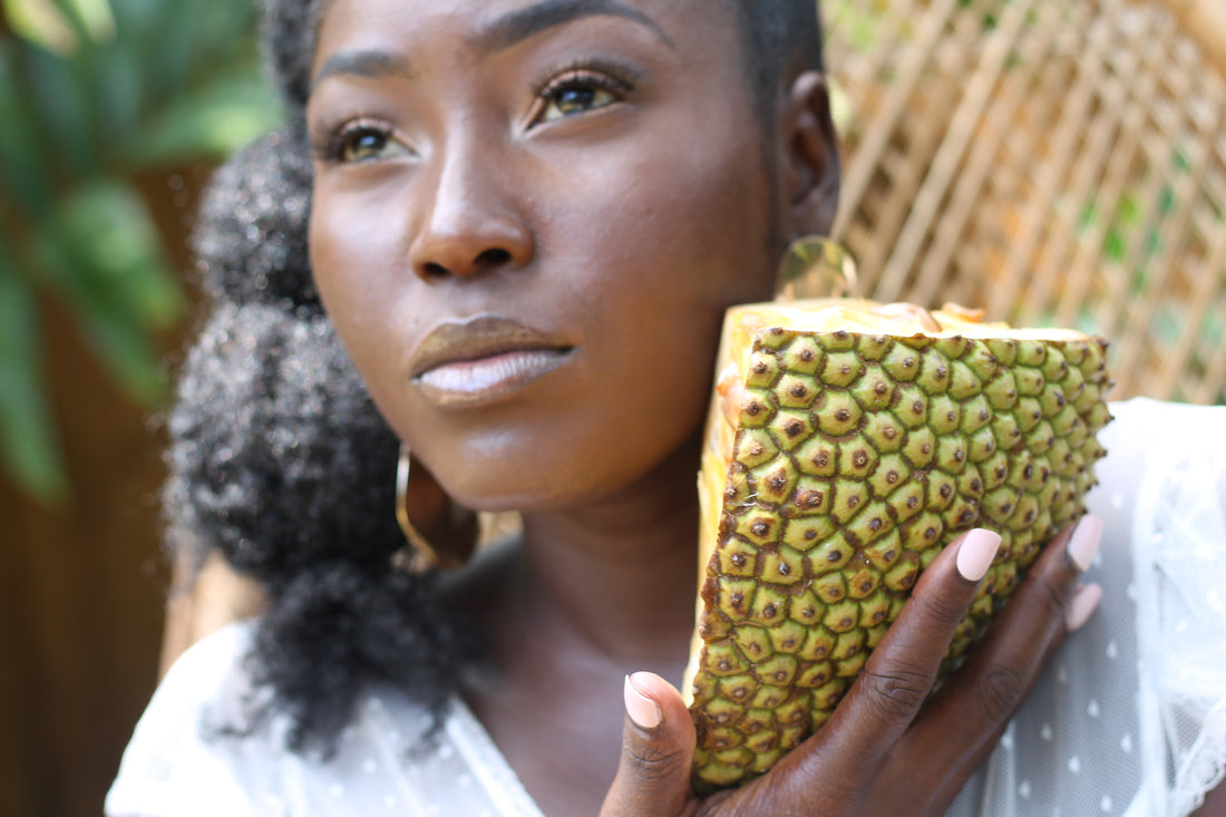 black woman holding papaya fruit 