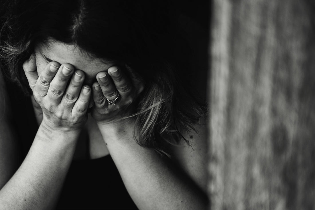 sad woman with face in hands